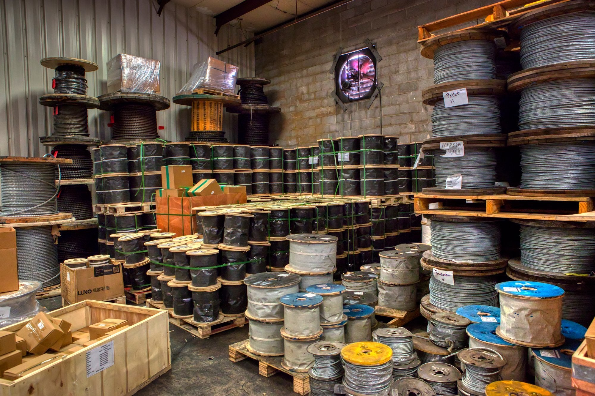 Spools of wire rope stacked in warehouse