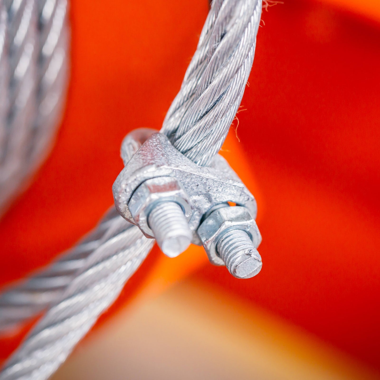 Wire rope clip clamped onto wire rope